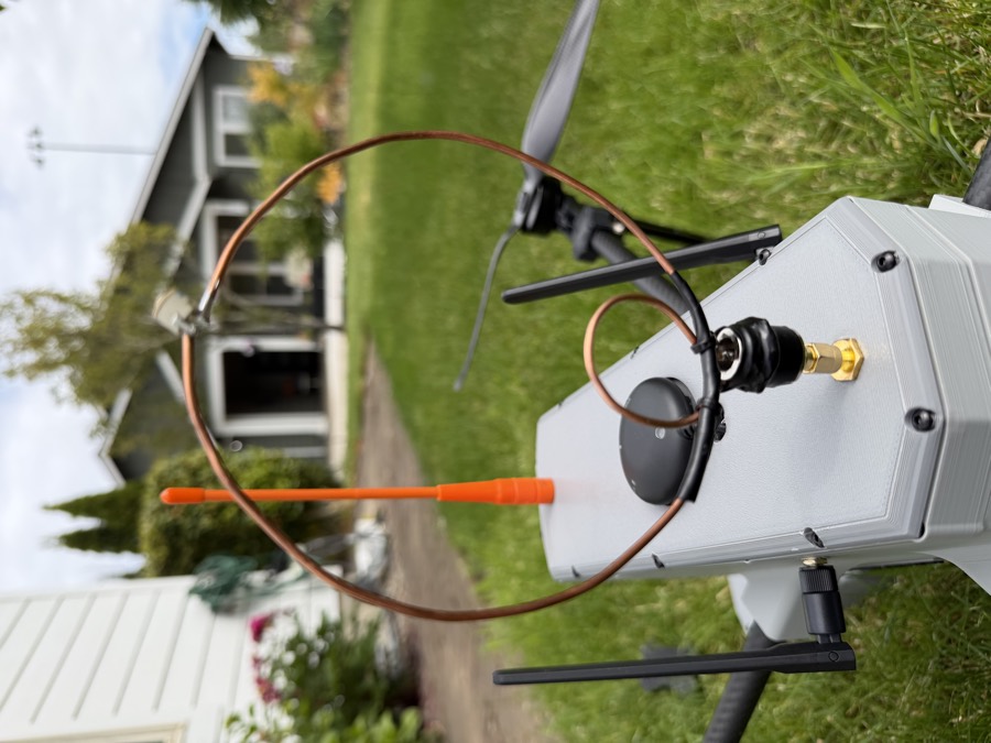 The circular VHF loop antenna mounted on top of the Aegis fuselage