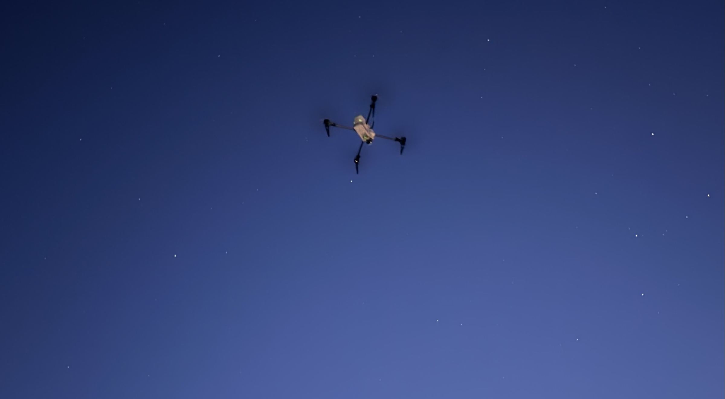 The Vexil Aegis aircraft in flight against a deep blue evening sky scattered with stars